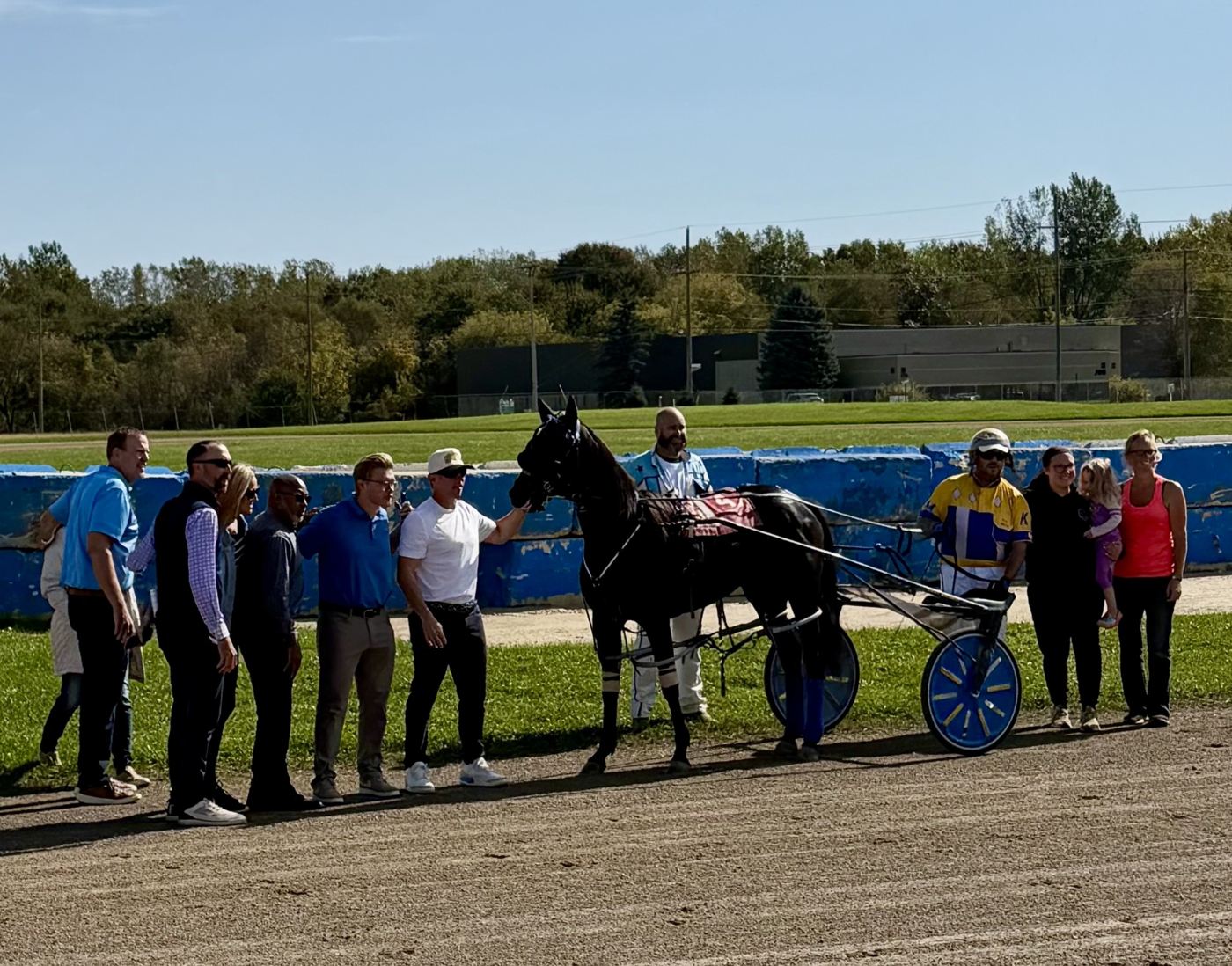 Honor's Miracle in the winner's circle with her connections after a race victory